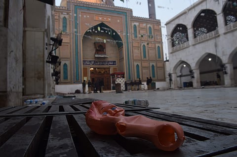 A doll lies on the ground of the 13th century Sufi shrine of Lal Shahbaz Qalandar a day after a bomb attack on February 17. (File Photo | AFP)