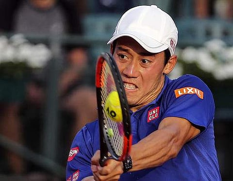 Kei Nishikori of Japan returns a shot to Carlos Berlocq of Argentina, during an ATP Argentina Open match in Buenos Aires. | AP