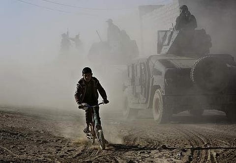 File photo of an Iraqi boy on his bicycle as he follows the special forces in Mosul.(File Photo |AP)