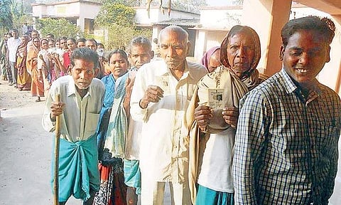 Voters queue outside a polling booth in Rengali of Sambalpur district | Express Photo Service