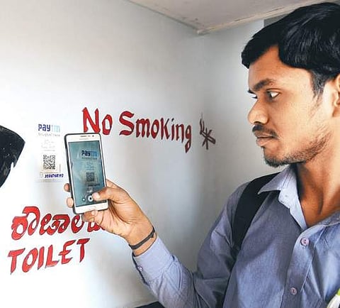 A customer making payment via Paytm at pay-and-use toilet near MCC
