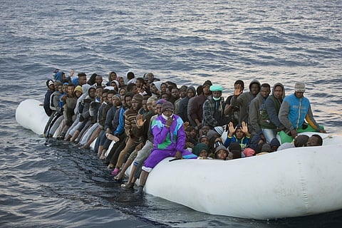 Migrants and refugees wait to be helped by members of the Spanish NGO Proactiva Open Arms, as they crowd aboard a rubber boat sailing out of control in the Mediterranean Sea. (File Photo | AP)