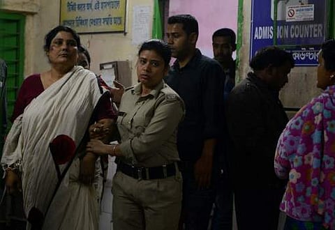 Indian police officials escort Chandana Chakraborty (L) from a police station in Jalpaiguri on February 21, 2017, for a medical check up to a hospital in the district of the eastern Indian state of West Bengal, after her arrest as part of an alleged child