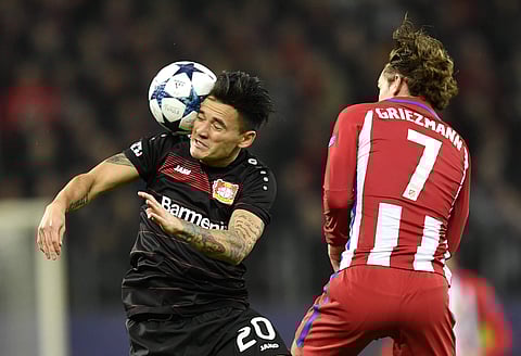 Leverkusen's Charles Aranguiz, left, and Atletico's Antoine Griezmann challenge for the ball during the Champions League round of 16 first leg soccer match between Bayer Leverkusen and Atletico Madrid in Leverkusen, Germany, Tuesday, Feb. 21, 2017. | AP