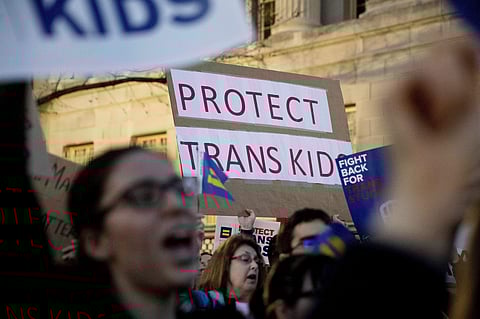 Activists and protesters with the National Center for Transgender Equality rally in front of the White House. (Photo | AP)