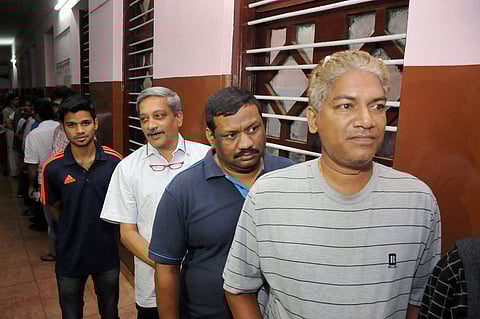 Defence Minister Manohar Parrikar in a queue outside a polling booth to cast his vote in Goa on Saturday. | PTI