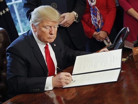 President Donald Trump signs an executive order in the Oval Office of the White House in Washington, Friday, Feb. 3, 2017.| AP