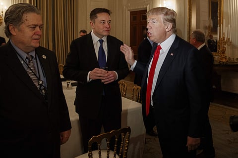 President Donald Trump talks with Tesla and SpaceX CEO Elon Musk, center, and White House chief strategist Steve Bannon during a meeting with business leaders in the State Dining Room of the White House in Washington, Friday, Feb. 3, 2017. | AP