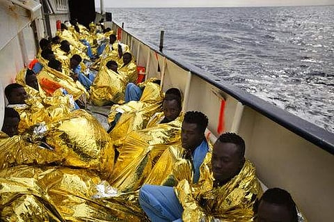 Sub-saharan migrants rest at the deck of Golfo Azzurro rescue ship after being rescued by members of the Spanish NGO Proactiva Open Arms, from a rubber boat sailing out of control in the Mediterranean Sea.