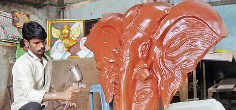 Selvam with a scupture; (below) Working on a bust of former CM J Jayalalithaa