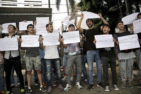 Refugees from Afghanistan hold placards during a protest outside the U.N. High Commissioner for Refugees office in Jakarta, Indonesia, Monday, Feb. 6, 2017. | AP