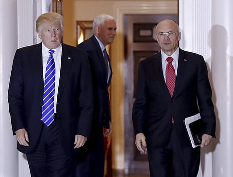 Donald Trump walks Labor Secretary-designate Andy Puzder from Trump National Golf Club Bedminster clubhouse in Bedminster, N.J.on Nov. 19, 2016 ( File photo | AP )