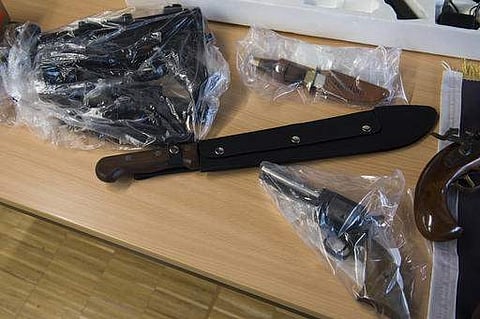 Seized items, including a machete, are on display during a police news conference in Goettingen, Germany, Thursday, Feb. 9, 2017. Twelve properties were searched in an operation. Police in central Germany say they have detained two known Islamic extremist
