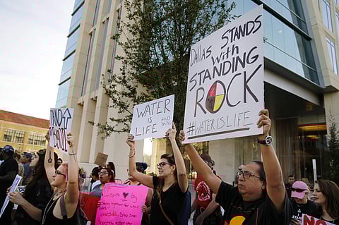 People standing outside developer Energy Transfer Partners headquarters protest the Army Corps of Engineers approval of the final section of the Dakota Access oil pipeline, Tuesday, Feb. 7, 2017.(Photo | AP)