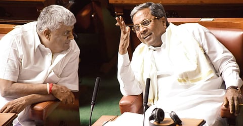 Chief Minister Siddaramaiah has a chat with H D Revanna during the Assembly session at Vidhana Soudha in Bengaluru on Wednesday | NAGARAJA GADEKAL