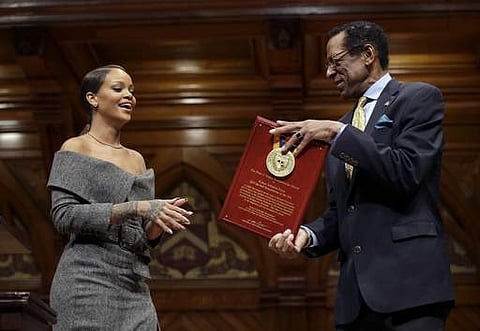 Singer Rihanna, left, is presented with the 2017 Harvard University Humanitarian of the Year Award on February 28. (Photo | AP)