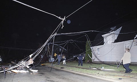 People walk through downed wires after a storm moved through Naplate, Ill., Tuesday, Feb. 28, 2017. (Photo | AP)