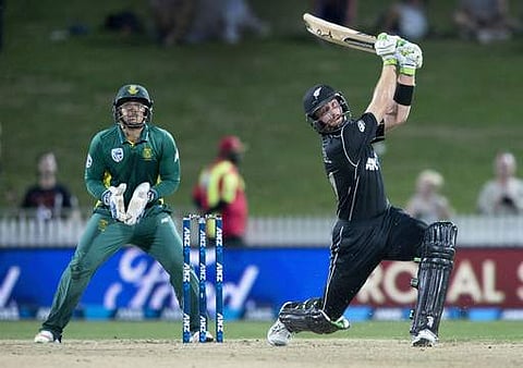 New Zealand batsman Martin Guptill, right, watches as he hits the ball for six runs during their one day cricket international match against South Africa at Seddon Park in Hamilton, New Zealand | AP