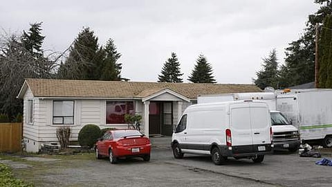 Vehicles are parked Sunday, March 5, 2017, at the home and driveway where a Sikh man was shot in the arm. (AP)