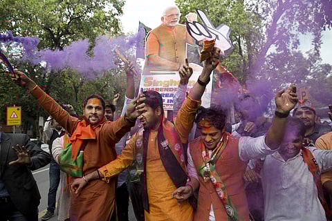 Bharatiya Janata Party (BJP) supporters celebrate as their party leads in state elections in Uttarakhand and Uttar Pradesh states in New Delhi, India, Saturday, March 11, 2017. | AP