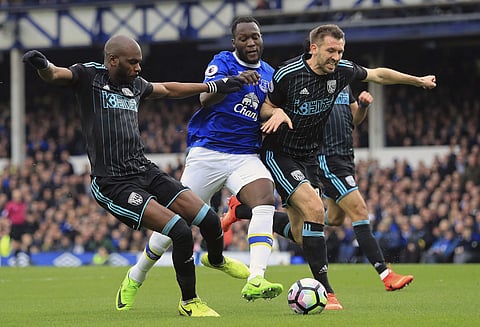Everton's Romelu Lukaku, center, battles for the ball with West Bromwich Albion's Allan Nyom, left, and Gareth McAuley during the English Premier League soccer match at Goodison Park. | AP