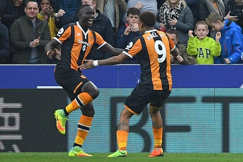Hull City's Senegalese striker Oumar Niasse (L) celebrates with Hull City's Uruguayan striker Abel Hernandez after scoring the opening goal of the EPL football match against Swansea City. | AFP