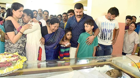 Diphan’s wife Deepa beside his body at their house in Kochi on Monday.
