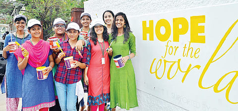 Students of Stella Maris painting graffitis on the wall