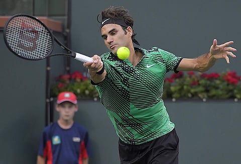 Roger Federer, of Switzerland, returns a shot against Steve Johnson at the BNP Paribas Open tennis tournament, Tuesday, March 14, 2017, in Indian Wells, Calif. | AP