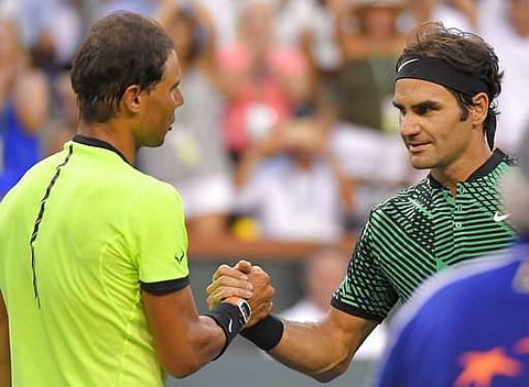 Roger Federer, of Switzerland, right, shakes hands with Rafael Nadal, of Spain, after their match at the BNP Paribas Open tennis tournament. (AP)