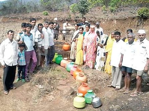 Villagers queue-up to collect water from the only well at Vadgaon village in Khanapur taluk. | Express Photo Service