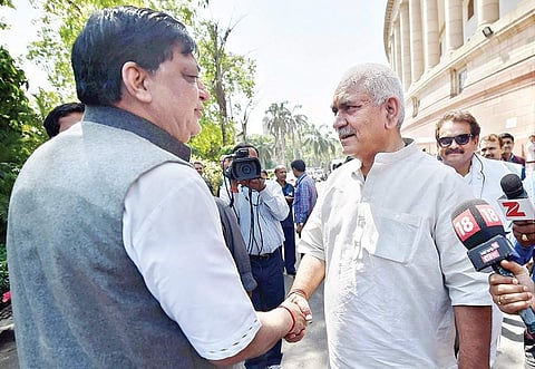 Manoj Sinha (R) shakes hands with SP MP Naresh Agrawal at Parliament House in New Delhi on Friday | PTI
