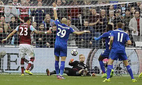 Leicester City goalkeeper Kasper Schmeichel, center, makes a save during the English Premier League soccer match between West Ham and Leicester City at London Stadium in London, Saturday, March 18, 2017. | AP