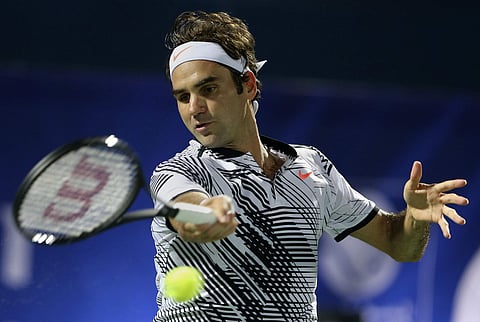Roger Federer of Switzerland returns the ball to Evgeny Donskoy, of Russia during the Dubai Tennis Championships, in Dubai, United Arab Emirates, Wednesday, March 1, 2017. | AP