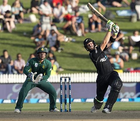 New Zealand batsman Martin Guptill, right, watches as he hits the ball for six runs during their one day cricket international match against South Africa at Seddon Park. | AP
