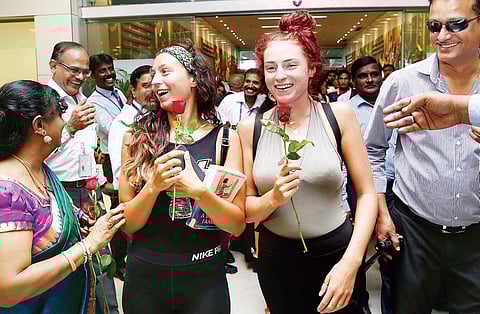 Passengers being received with rose flowers at Chennai Airport as part of ‘Smile Week’ celebrations on Wednesday | sunish p surendran