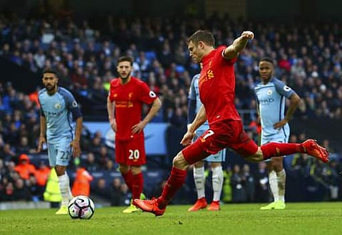 Liverpool's James Milner scores the opening goal from the penalty spot during the English Premier League soccer match between Manchester City and Liverpool at the Etihad Stadium in Manchester. (AP)