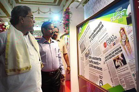 Chief Minister Siddaramaiah looking at a display of the budget coverage in newspapers at an event organised by the Department of Information and Public Relations at Vidhana Soudha in Bengaluru on Wednesday | NAGESH POLALI