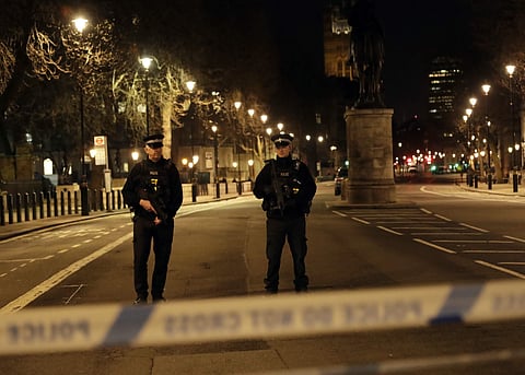 Two policemen stand guard at a cordoned off area on the way to the Houses of Parliament in central London. (Photo | AP)