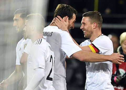 Germany's scorer Lukas Podolski, right, and his teammate Mats Hummels, 2nd right, celebrate the opening goalduring the friendly soccer match between Germany and England in Dortmund, Germany, Wednesday, March 22, 2017. | AP