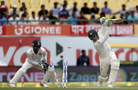 Australia's Peter Handscomb, right, is dismissed by India's Kuldeep Yadav during the first day of their fourth test cricket match in Dharmsala, India, Saturday, March 25, 2017. | AP