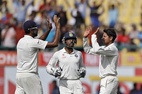 India's Kuldeep Yadav, right, and Ravichandran Ashwin, left, celebrate the dismissal of Australia's Pat Cummins during the first day of their fourth test cricket match in Dharmsala (Photo | AP)