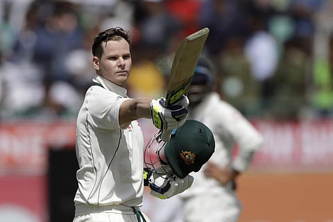 Australia's captain Steven Smith raises his bat after scoring century during the first day of their fourth test cricket match against India in Dharmsala, India, Saturday, March 25, 2017. | AP