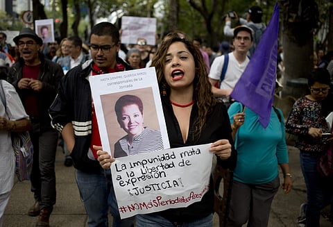 A woman shouts slogans holding a photo of Mexican journalist Miroslava Breach, gunned down, and a sign that reads in Spanish: 'the impunity kills freedom of speech, justice,'. (Photo | AP)