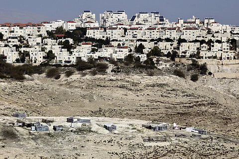 In this Jan. 22, 2017 file photo, the Israeli settlement of Maaleh Adumim looms over Arab Bedouin shacks in the West Bank, Sunday, Jan. 22, 2017. | AP