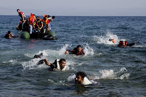 Migrants whose boat stalled at sea while crossing from Turkey to Greece swim to approach the shore of the island of Lesbos, Greece. (File | AP)