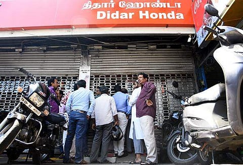 Peoples gathered outside a two wheeler showroom which is close after the discount sale of BS3 Vechicles at a showroom in mount road on friday.(Photo | Ashwin Prasath)
