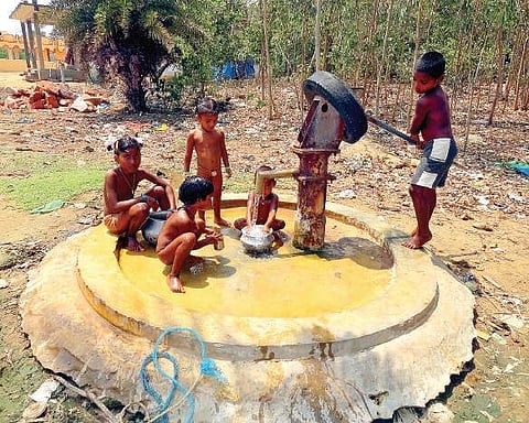 Children taking a bath at a tube well at D Matsalesam in Etcherla mandal in Srikakulam district on Thursday | Express Photo Service