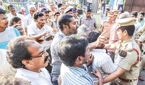 Villagers being prevented by the police from entering the premises of Ananda aqua preprocessing unit at Nallamvarithota in West Godavari district on Thursday after the mishap | Express