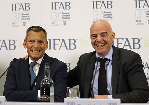 Football Association , FA, CEO Martin Glenn, left, and FIFA President Gianni Infantino smile during a press conference after the 131st International Football Association Board (IFAB) annual general meeting at Wembley stadium in London, Friday, March 3, 20